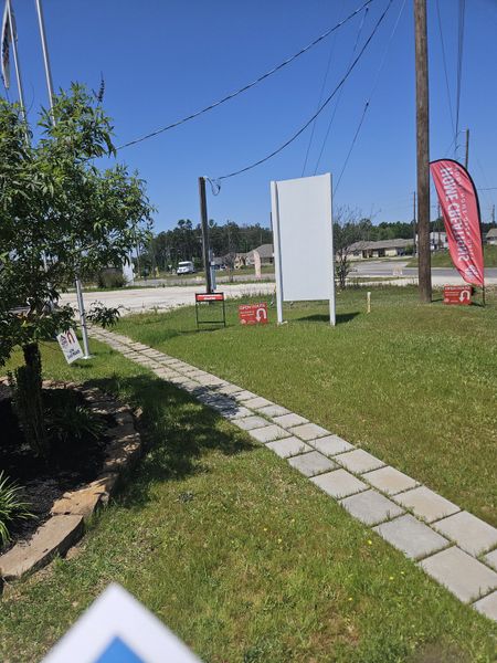 A picturesque entrance path in Santa Fe by Home Creations in Cleveland, TX, guiding through a lush and inviting landscape.