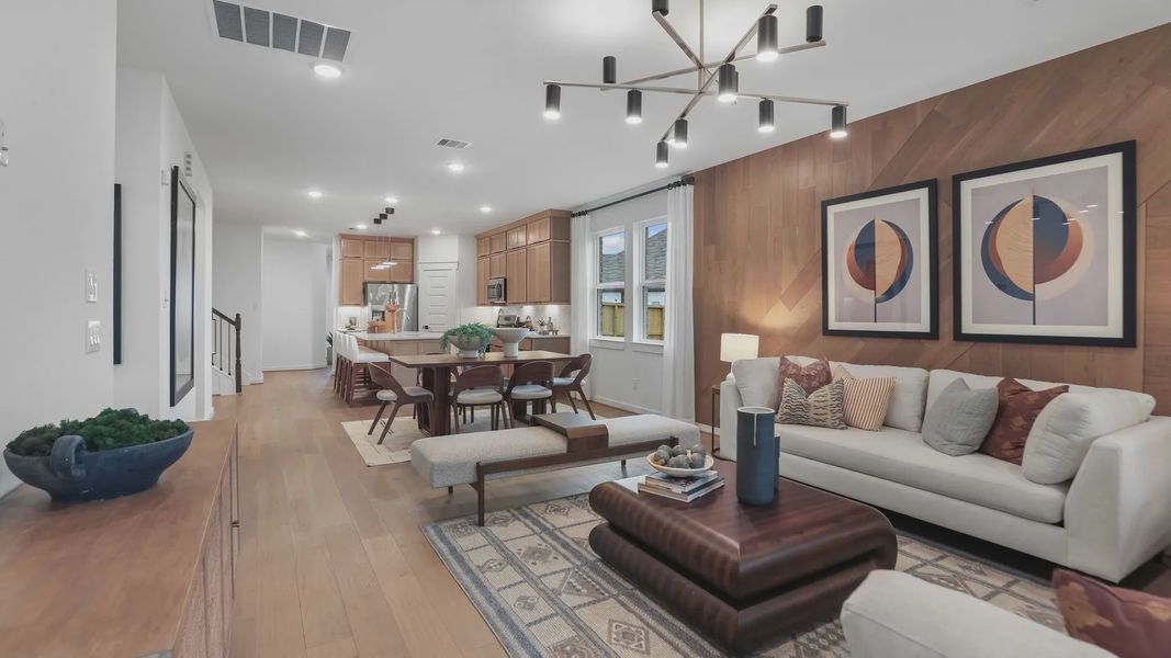 Luxurious wood-paneled walls and chic chandelier enhance this Mostyn Springs living space's elegance. Luxurious wood-paneled walls and chic chandelier enhance this Mostyn Springs living space's elegance.