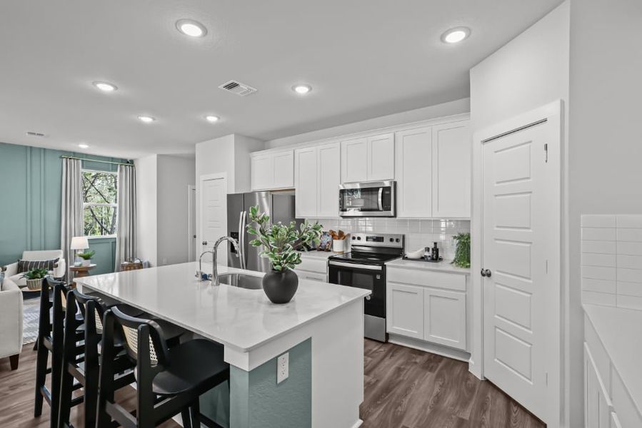 A kitchen with white cabinets. A kitchen with white cabinets.