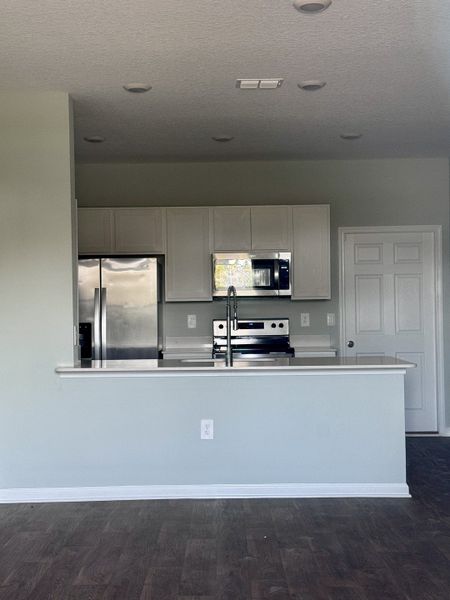 A modern kitchen with stainless steel appliances, white cabinets, and a sleek countertop for a contemporary look. A modern kitchen with stainless steel appliances, white cabinets, and a sleek countertop for a contemporary look.