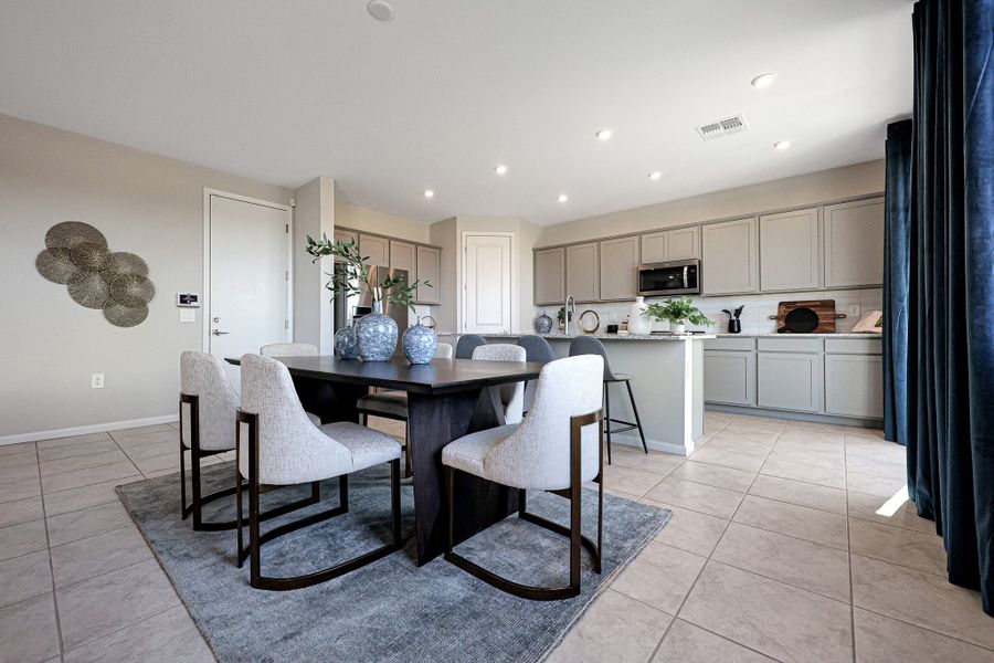 A kitchen with a dining table and chairs. A kitchen with a dining table and chairs.