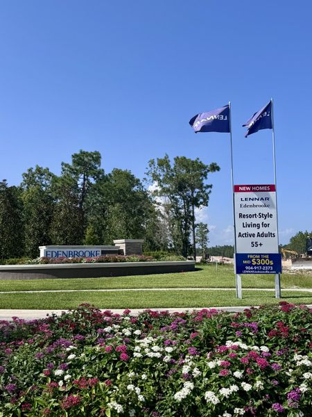 A vibrant landscaped entrance with colorful flowers welcomes you to Edenbrooke at Hyland Trail by Lennar (Green Cove Springs, FL).