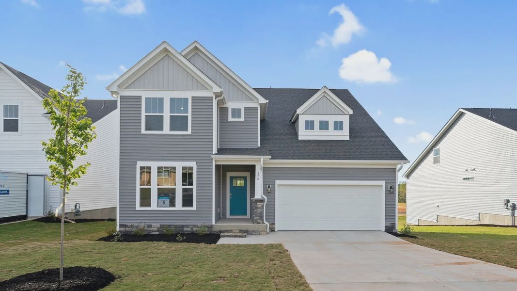 DRB Homes' Woodglen in Piedmont, SC offering the Drayton floorplan, shown here with gray exterior siding