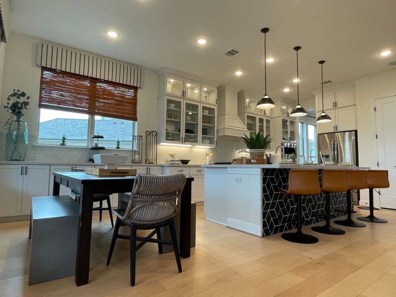 A modern kitchen with sleek cabinetry, island seating, pendant lights, and natural wood accents for a stylish look. A modern kitchen with sleek cabinetry, island seating, pendant lights, and natural wood accents for a stylish look.