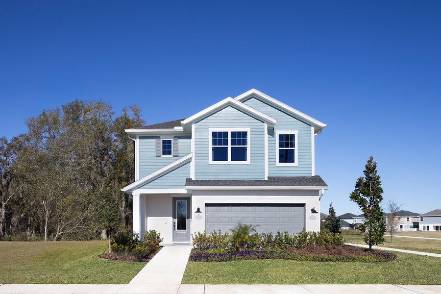 Front exterior of a home in the Persimmon Place – Garden Series community, located in Wesley Chapel, FL (Image 12).