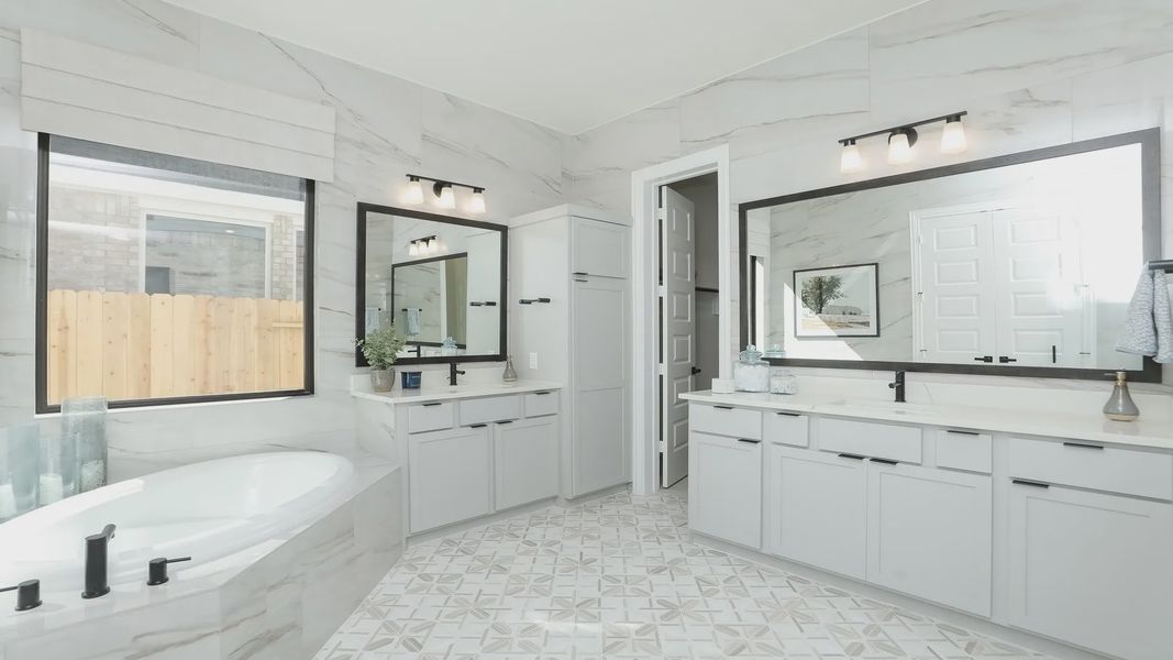 Experience refined luxury with marble tile, dual vanities, and an inviting tub in Brookewater. Experience refined luxury with marble tile, dual vanities, and an inviting tub in Brookewater.