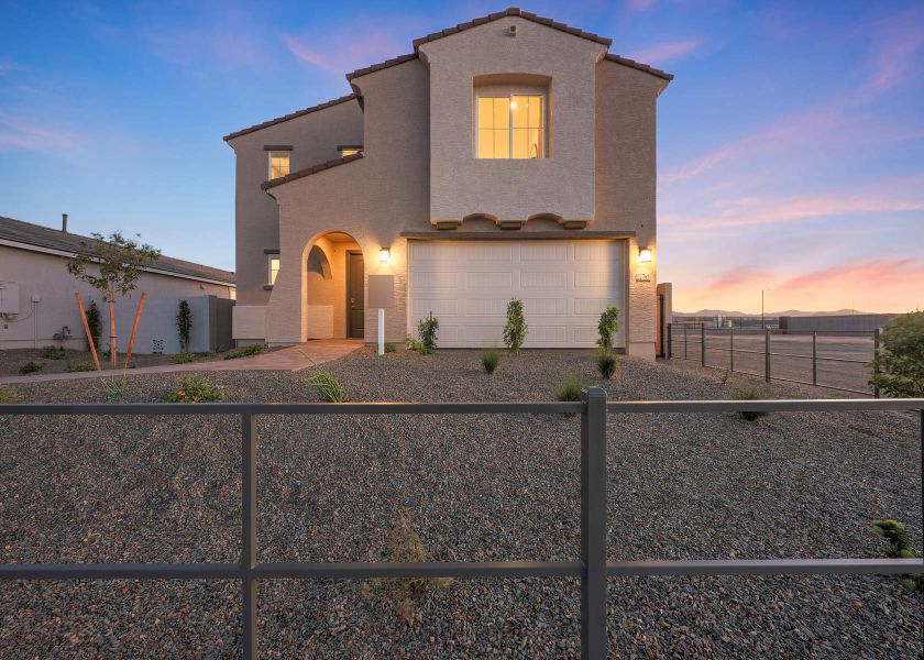 A house with a fence in front.