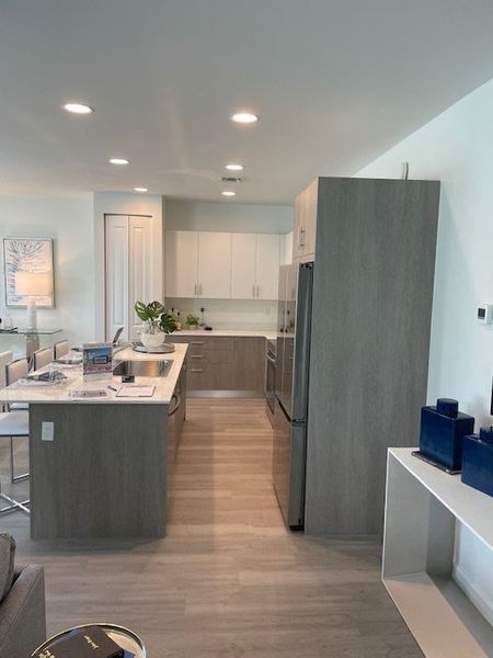 A modern kitchen with sleek cabinetry, a spacious island, and contemporary lighting.