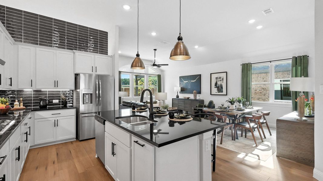 Explore elegance at Green Oaks Preserve. White cabinetry, sleek black countertops, exquisite lighting in a spacious layout. Explore elegance at Green Oaks Preserve. White cabinetry, sleek black countertops, exquisite lighting in a spacious layout.