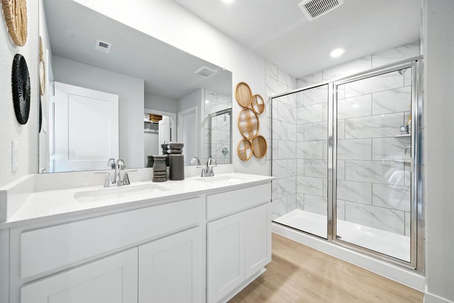 A bathroom with a glass shower. A bathroom with a glass shower.