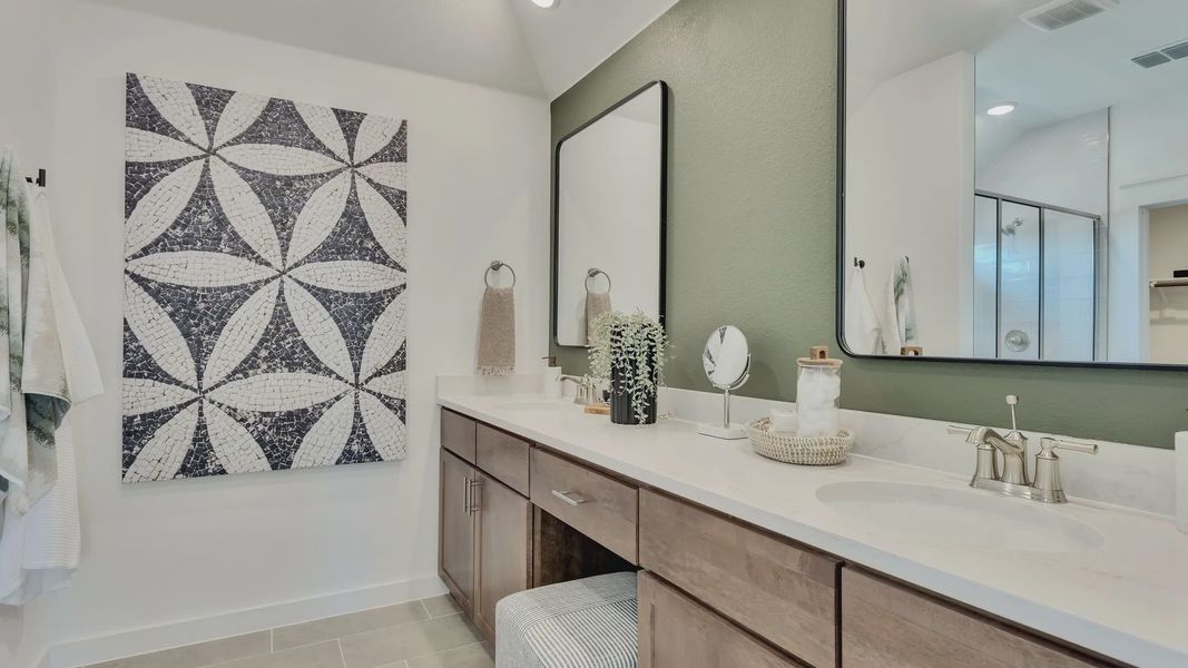 Dual sinks with marble counters and chic tile art elevate luxury in Hunters Glen. Dual sinks with marble counters and chic tile art elevate luxury in Hunters Glen.