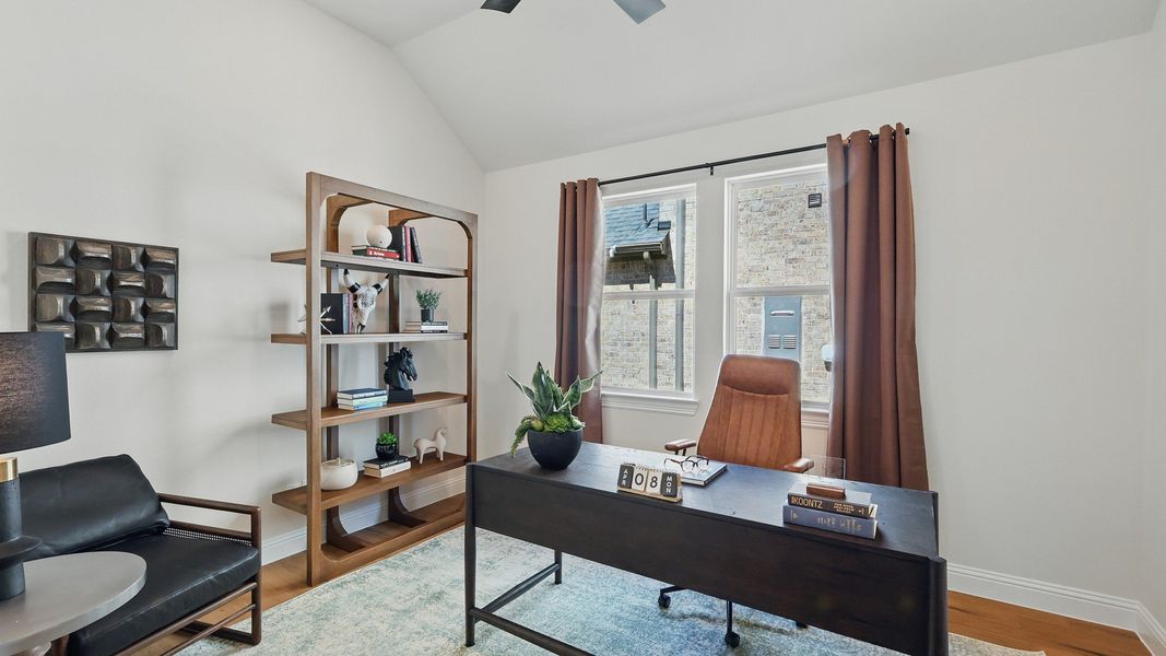 Luxurious office with vaulted ceiling and oak flooring, blending elegance and functionality in Green Oaks Preserve. Luxurious office with vaulted ceiling and oak flooring, blending elegance and functionality in Green Oaks Preserve.