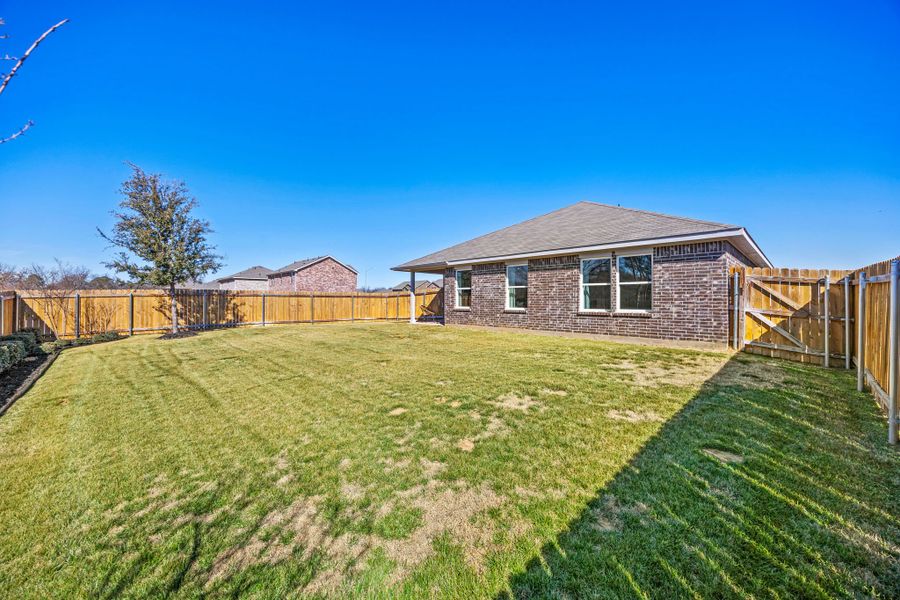 A house with a fence and grass. A house with a fence and grass.