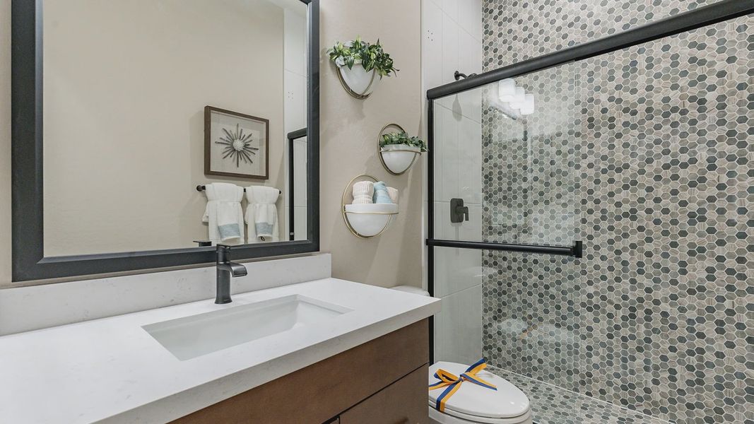 This elegant bathroom in Arroyo Seco features distinctive hexagonal tiles and chic modern fixtures. This elegant bathroom in Arroyo Seco features distinctive hexagonal tiles and chic modern fixtures.