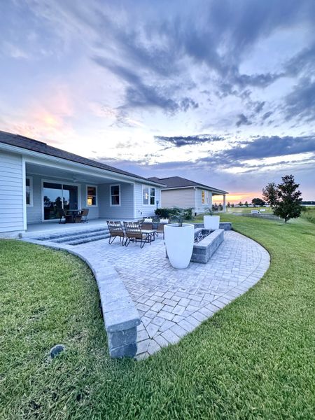 A charming patio with manicured lawn and sunset views in Lakes at Bella Lago by Mattamy Homes (Green Cove Springs, FL). A charming patio with manicured lawn and sunset views in Lakes at Bella Lago by Mattamy Homes (Green Cove Springs, FL).
