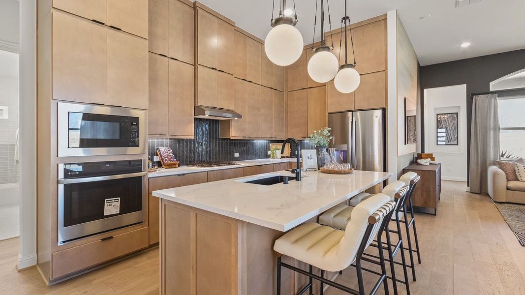 Discover the allure of custom wooden cabinetry and sleek white countertops in River Ranch's modern kitchen.