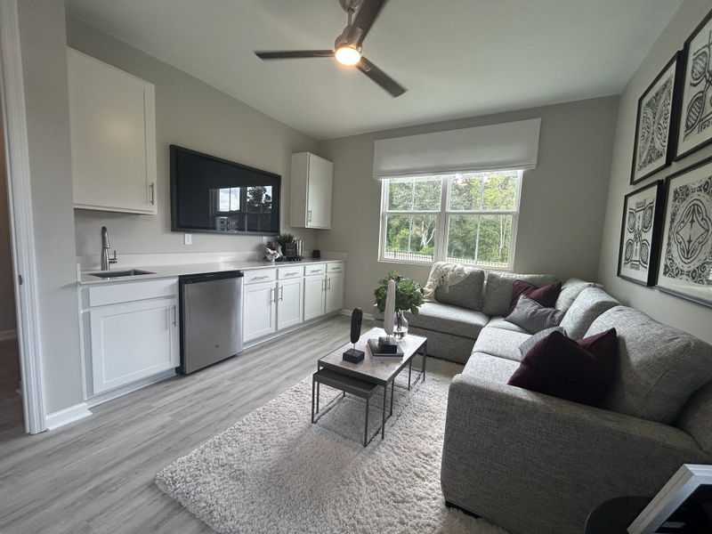 A cozy living room with a neutral palette, L-shaped sofa, sleek cabinetry, and stylish decor. A cozy living room with a neutral palette, L-shaped sofa, sleek cabinetry, and stylish decor.