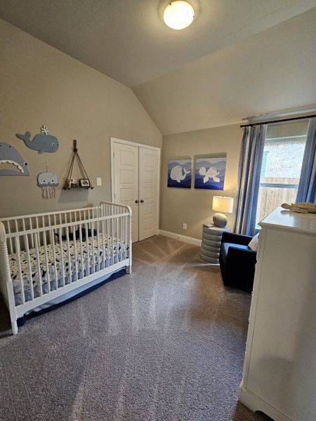 A cozy nursery featuring a white crib, ocean-themed decor, plush carpet, and soft lighting, creating a serene ambiance. A cozy nursery featuring a white crib, ocean-themed decor, plush carpet, and soft lighting, creating a serene ambiance.