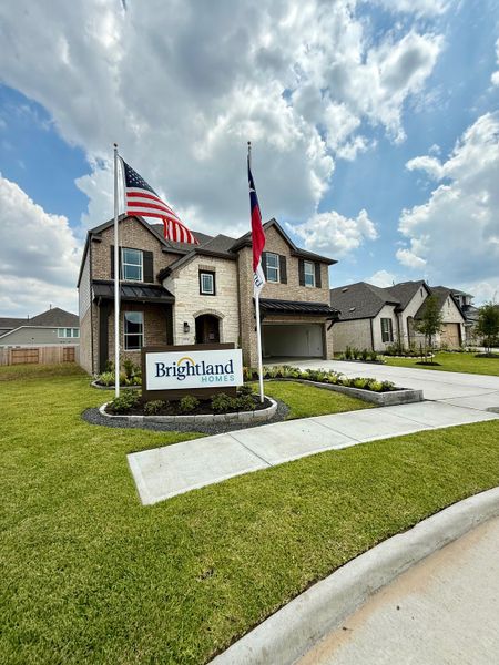 A beautiful brick and stone home with manicured landscaping in Park at Eldridge by Brightland Homes (Sugar Land, TX).
