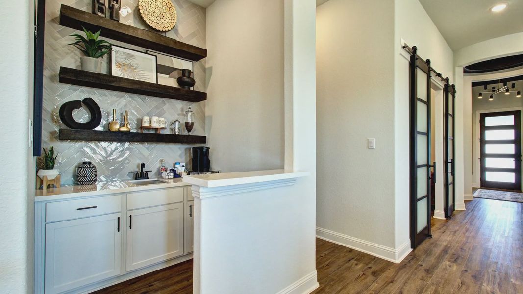 Luxurious herringbone tile and hardwood floors meet sleek dark shelving in Meyer Ranch's contemporary design. Luxurious herringbone tile and hardwood floors meet sleek dark shelving in Meyer Ranch's contemporary design.