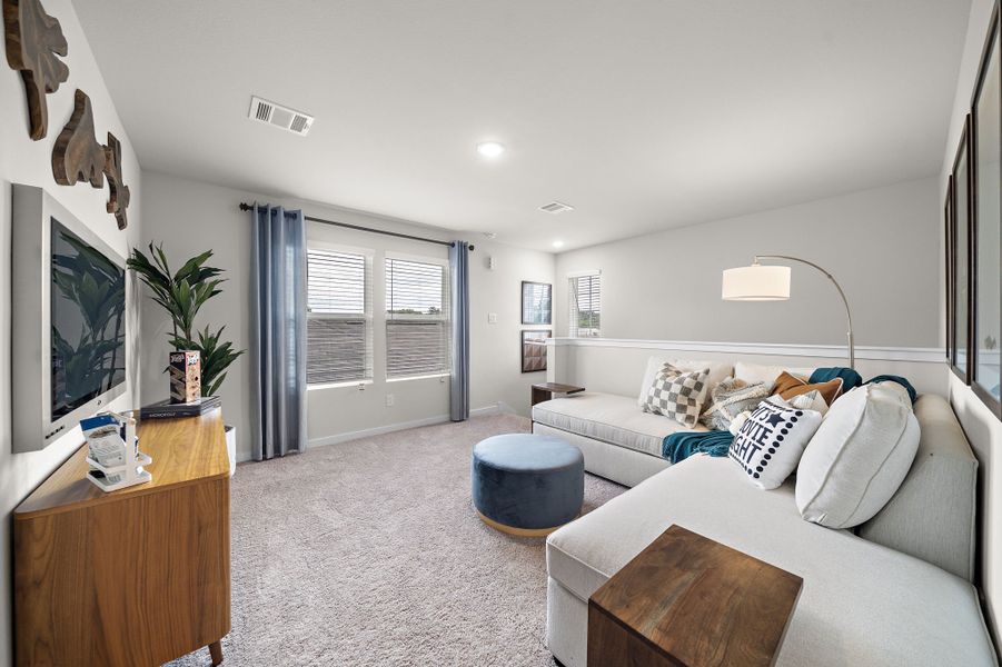 A living room with a couch and a tv.
