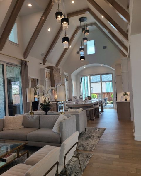A luxurious living room boasts high vaulted ceilings, elegant lighting, and cozy seating areas, blending style with comfort. A luxurious living room boasts high vaulted ceilings, elegant lighting, and cozy seating areas, blending style with comfort.