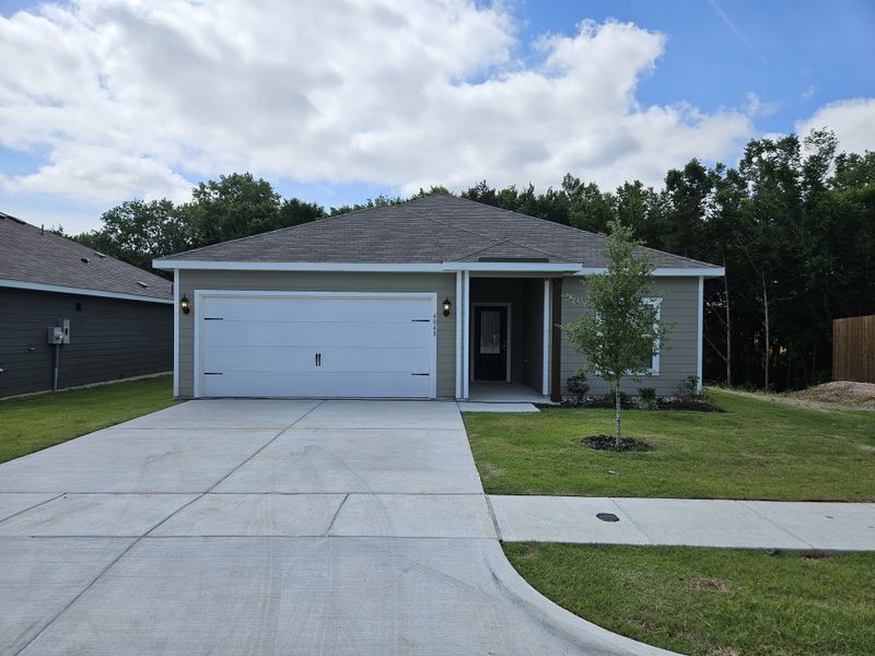 A modern single-story home with a spacious driveway and neat landscaping in College Park by LGI Homes (Dallas, TX).