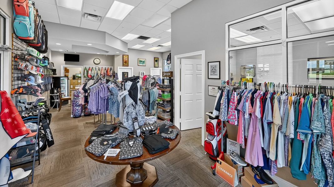 Pro shop with racks of clothing and golf accessories