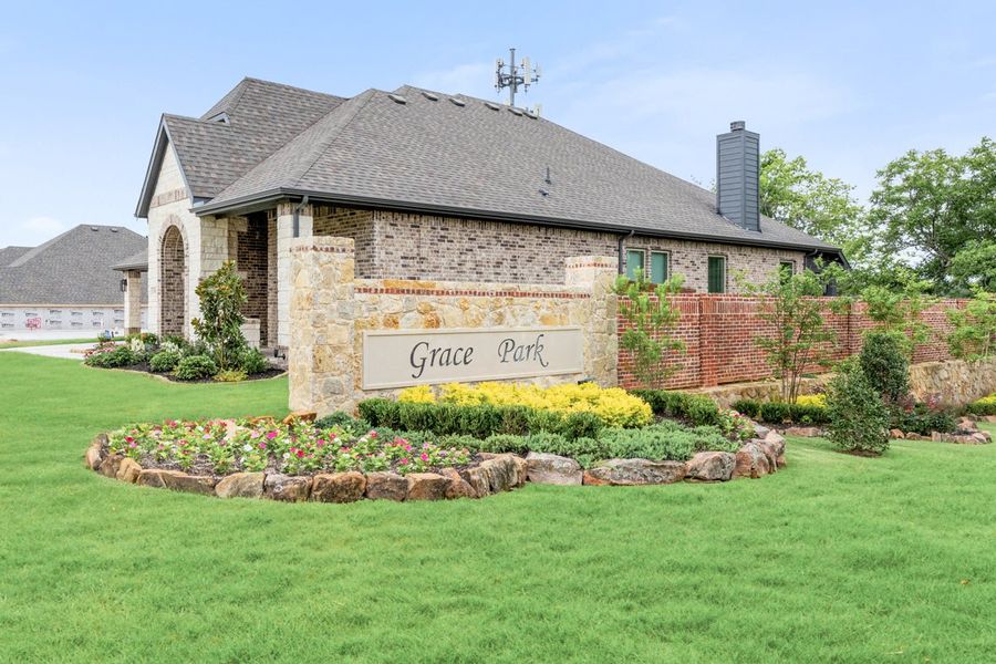 Grace Park neighborhood entrance sign with stone monument, flower beds, and brick building behind landscaped lawn Grace Park neighborhood entrance sign with stone monument, flower beds, and brick building behind landscaped lawn