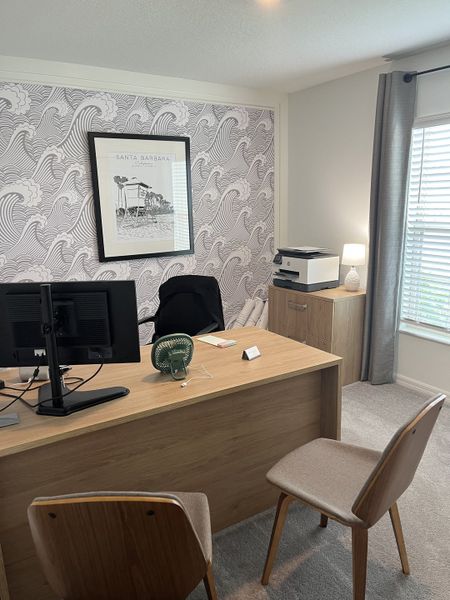 A modern home office with a wood desk, patterned wallpaper, and soft lighting, perfect for productivity and style. A modern home office with a wood desk, patterned wallpaper, and soft lighting, perfect for productivity and style.