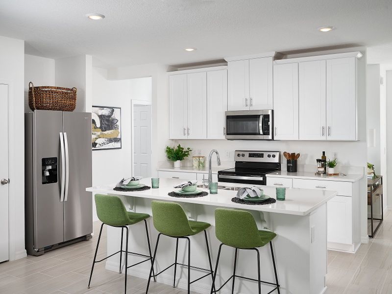 Kitchen in Acadia floorplan modeled at Lake Deer Estates