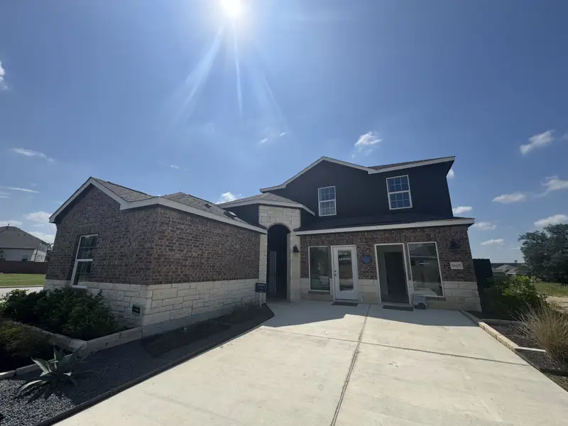 A beautiful brick home with modern accents and a lush garden in Lively Ranch: Claremont Collection by Lennar (Georgetown, TX).