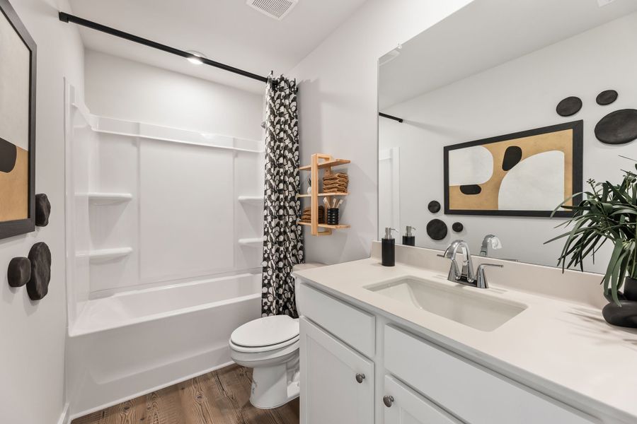 A bathroom with a tub sink and toilet. A bathroom with a tub sink and toilet.
