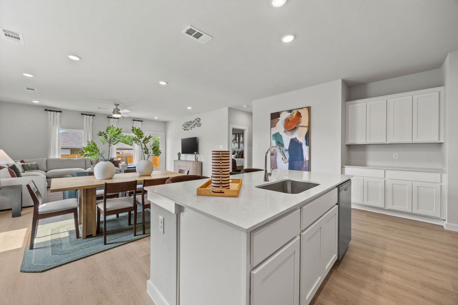 A kitchen with a dining table and a sink. A kitchen with a dining table and a sink.