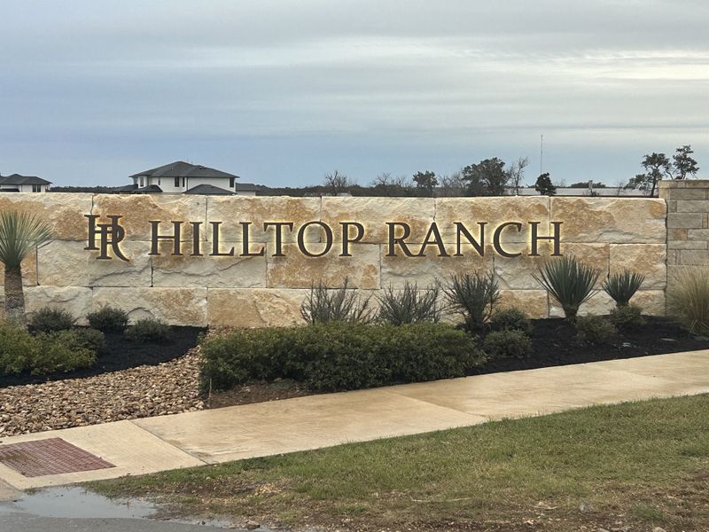 Entrance to the Hilltop Ranch community in Leander, TX, featuring signage and landscaping (Image 1). Entrance to the Hilltop Ranch community in Leander, TX, featuring signage and landscaping (Image 1).