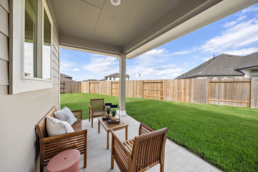 A patio with chairs and a table.