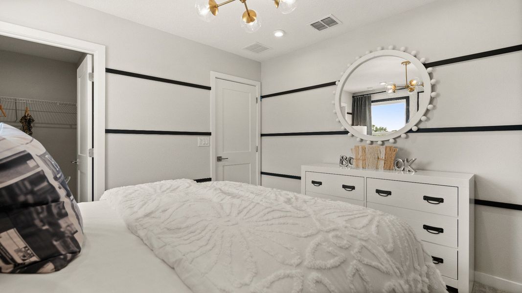 Guest bedroom at the Jupiter Model, this is featuring a bright space with a large window allowing lots of natural light.