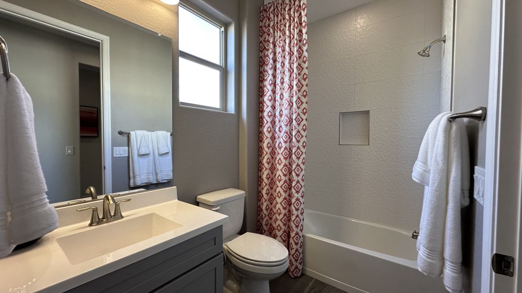 Furnished interior in a model home at CantaMia at Estrella 55+ in Goodyear (Image 22).