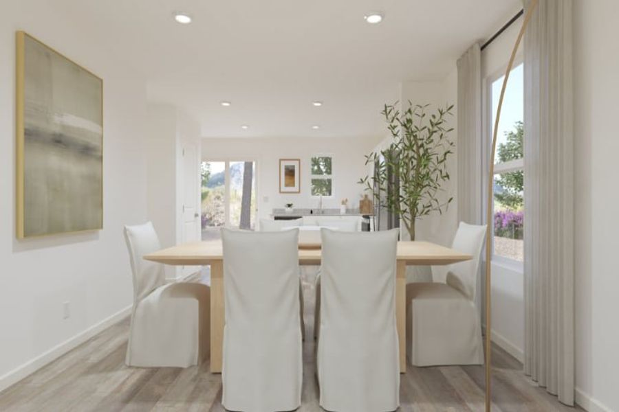 A dining room with a table and chairs.