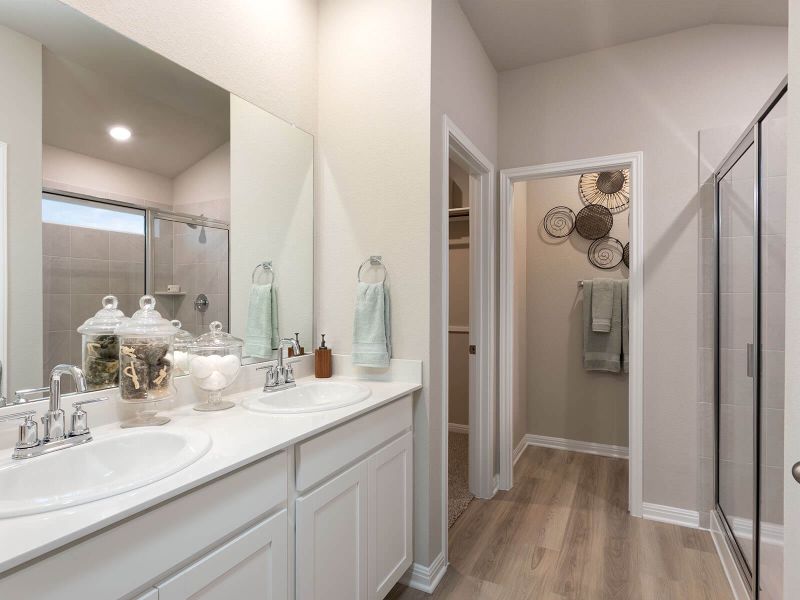 Enjoy dual sinks and an oversized walk-in shower in the primary bathroom.