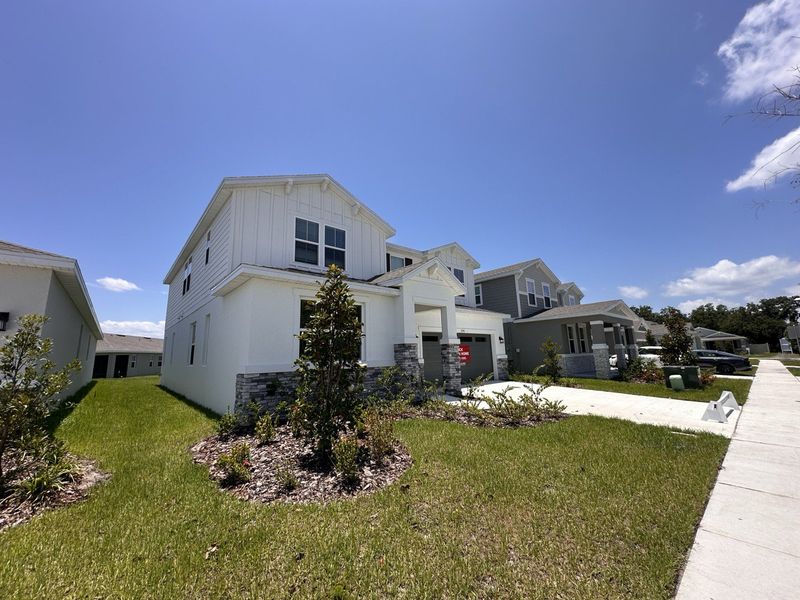 A charming white home with stone accents and a manicured lawn in Seasons at Big Sky by Richmond American Homes (Kissimmee, FL). A charming white home with stone accents and a manicured lawn in Seasons at Big Sky by Richmond American Homes (Kissimmee, FL).