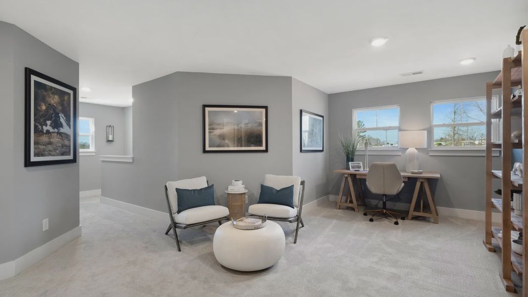 Cozy upstairs loft with plush carpet at Barton Hollow by DRB Homes in Fountain Inn, SC