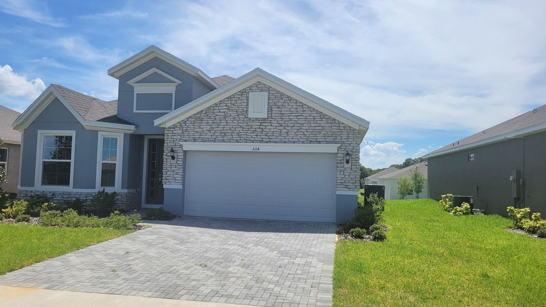 A charming home with a stone facade and manicured lawn in Seaport Village by Dream Finders Homes (Tavares, FL). A charming home with a stone facade and manicured lawn in Seaport Village by Dream Finders Homes (Tavares, FL).