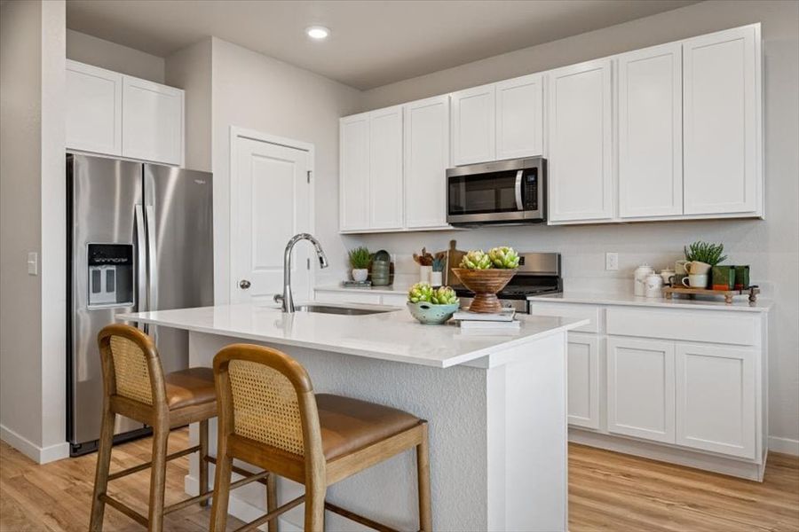 A kitchen with white cabinets. A kitchen with white cabinets.