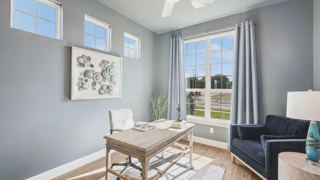 Luxurious office features expansive windows, sleek ceiling fan, and sophisticated decor in Ridge Crossing. Luxurious office features expansive windows, sleek ceiling fan, and sophisticated decor in Ridge Crossing.