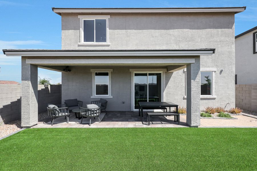 A house with a lawn and chairs. A house with a lawn and chairs.