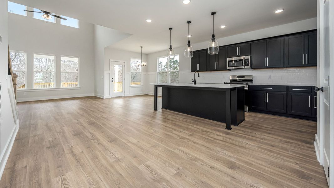 First floor open concept with sleek kitchen design and high ceilings First floor open concept with sleek kitchen design and high ceilings