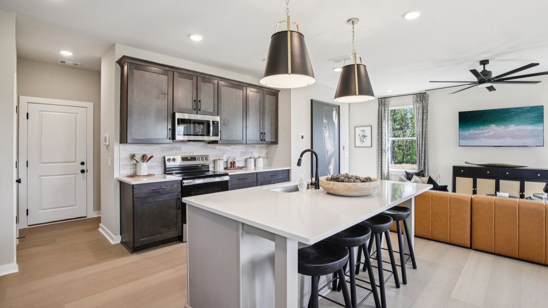 View of kitchen and nearby living room