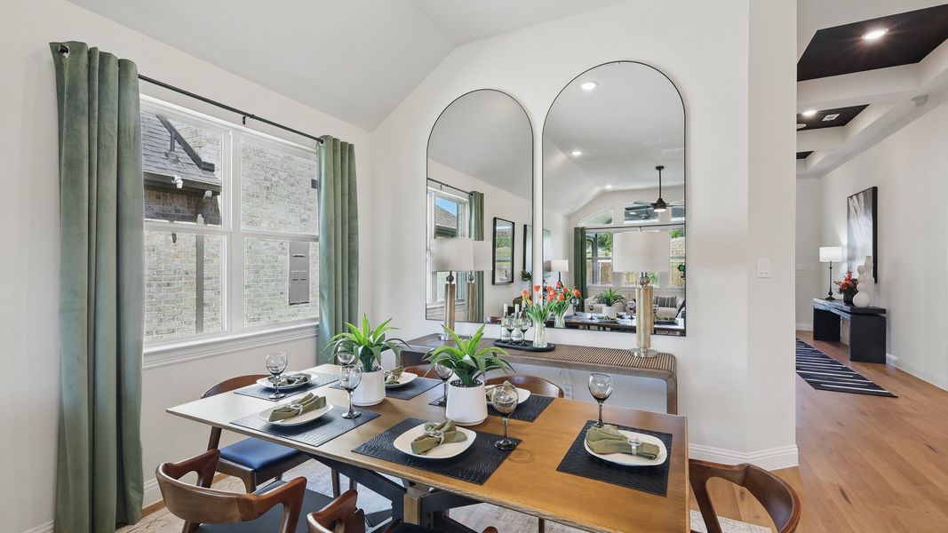 Luxurious dining room with vaulted ceiling and expansive mirrors in Green Oaks Preserve community. Luxurious dining room with vaulted ceiling and expansive mirrors in Green Oaks Preserve community.