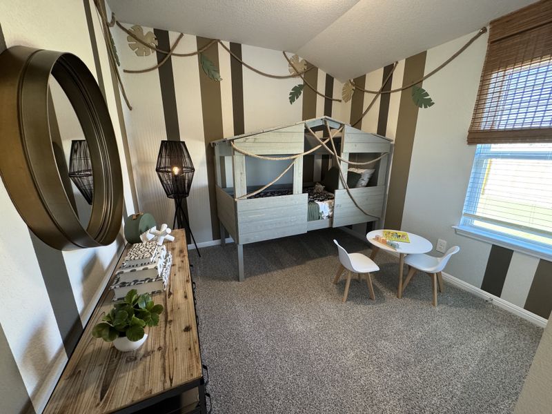 A playful kids' room with a cabin-style bed, striped walls, and a small table set, perfect for imaginative adventures.